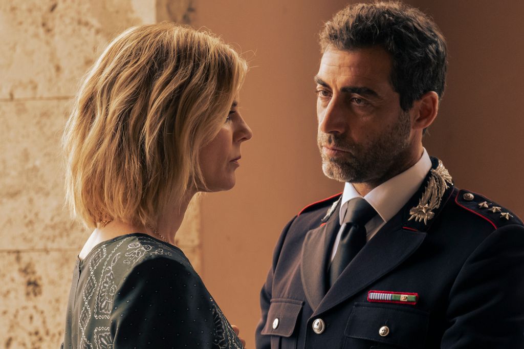 blonde woman looking at man in uniform