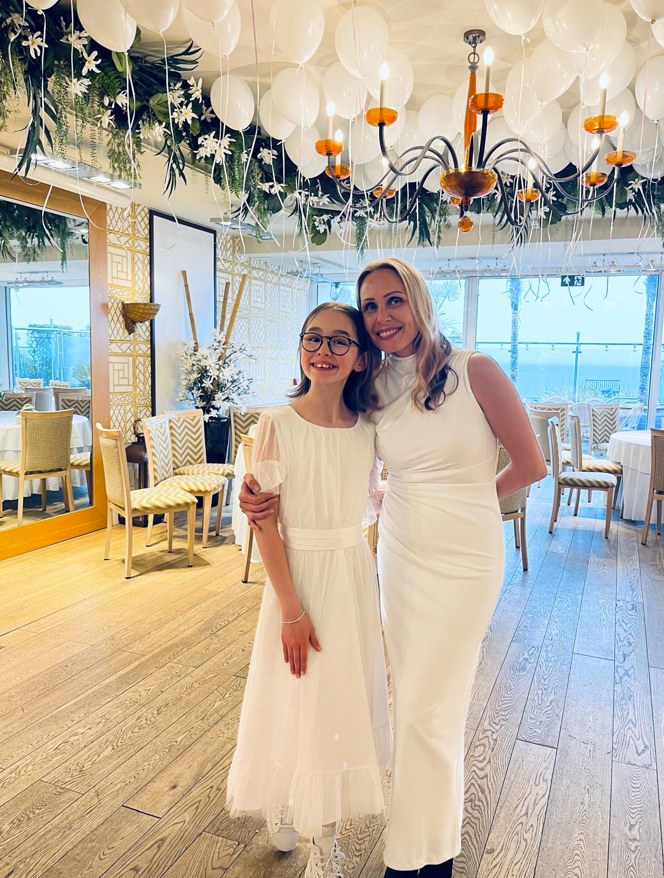 Skye and Christina smiling in white dresses