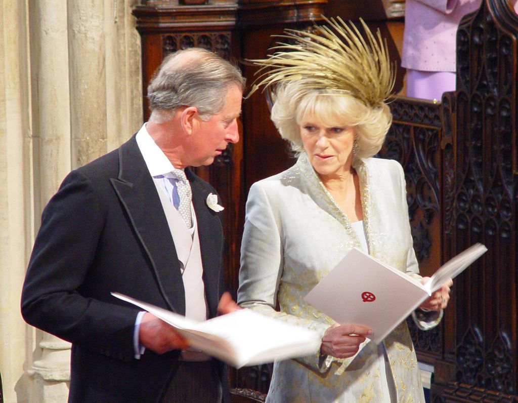 Charles and Camilla holding order of service