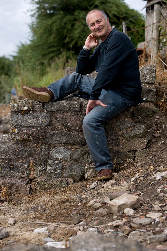 man posing on stone wall 