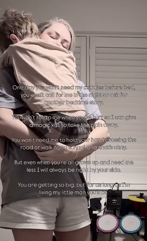 Danny Jones' wife Georgia holds son Cooper in her arms while standing in the playroom