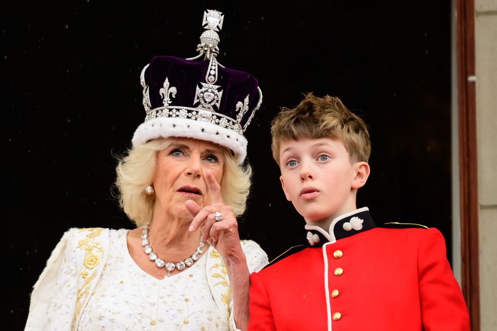 Queen Camilla talking to her grandson Freddy Parker Bowles on the Buckingham Palace balcony
