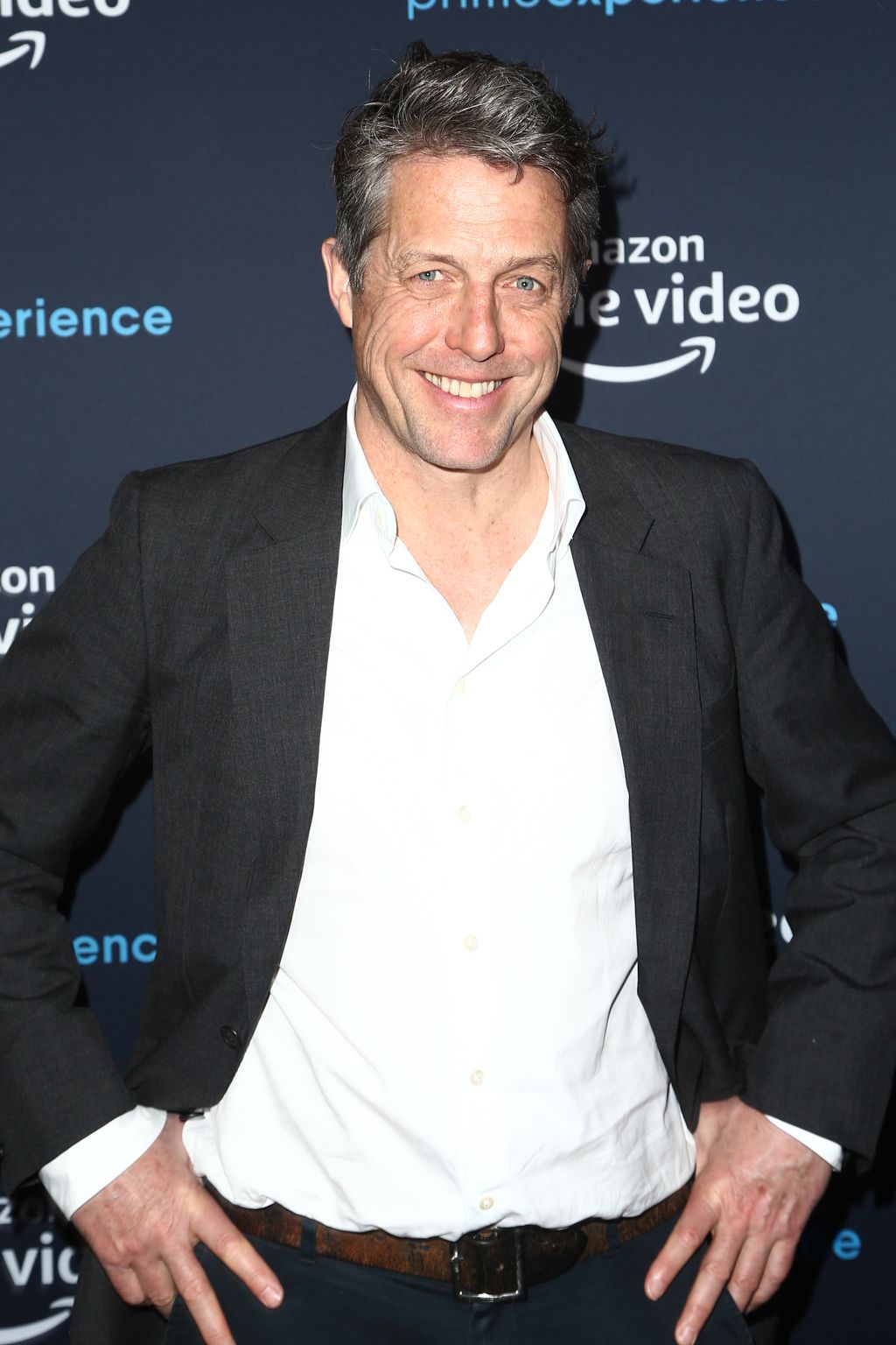 Hugh Grant smiling at a red carpet event