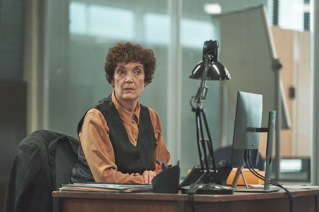 Woman with brunette hair sitting at desk