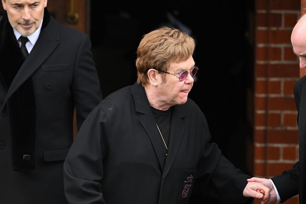 Elton John seen departing after the funeral
