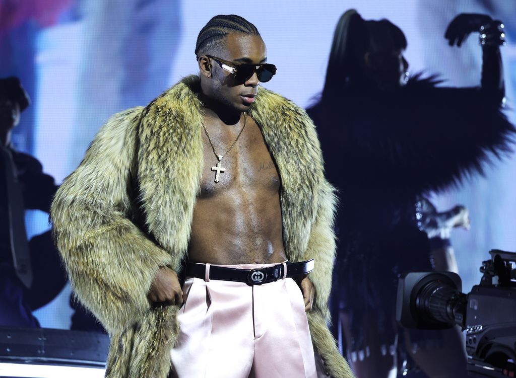 David Banda on stage during Madonna's tour in a fluffy green jacket