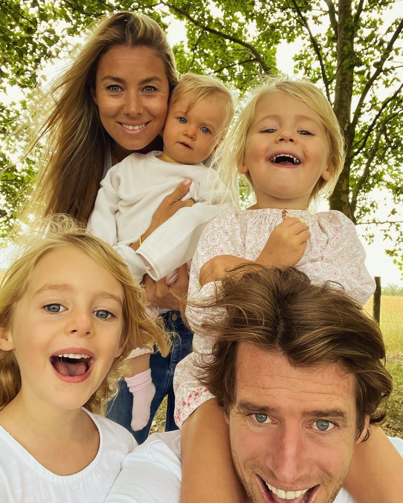 father taking selfie with family 