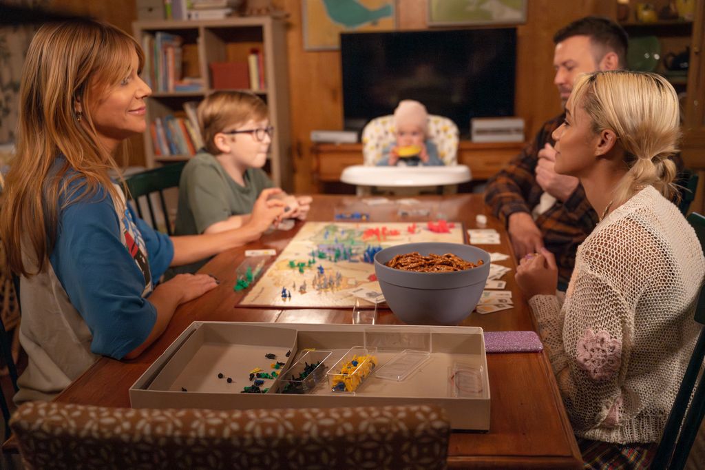 KAITLIN OLSON, MATTHEW LAMB, TARAN KILLAM, AMIRAH JOHNSON SIT AROUND A TABLE IN SCENE FROM HIGH POTENTIAL