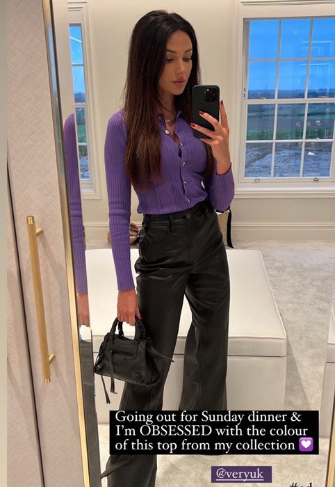 michelle keegan wearing purple top and leather trousers