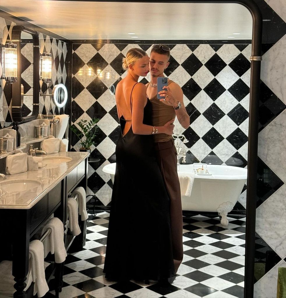 mia regan and romeo beckham posing in marble bathroom 