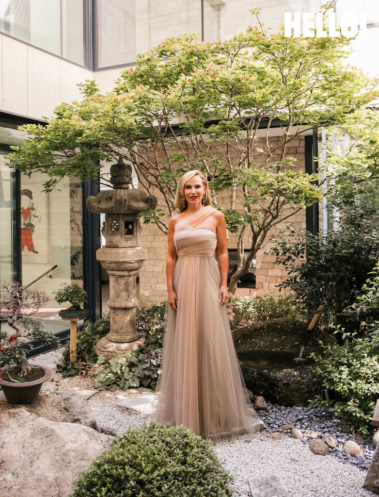 Victoria outside in a biege dress