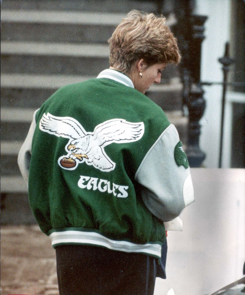 Walking away with confidence, Princess Diana showcases the bold Eagles logo on her jacket. The oversized fit, sporty aesthetic, and casual stance make this a timeless street-style moment.