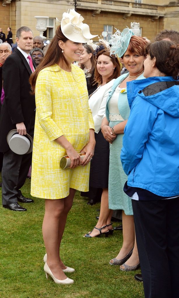 Princess Kate in a yellow dress that showed off her baby bump in 2013