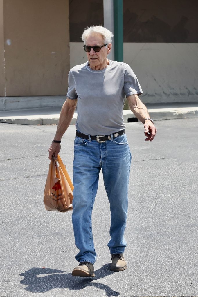 Harrison Ford in gray top and jeans