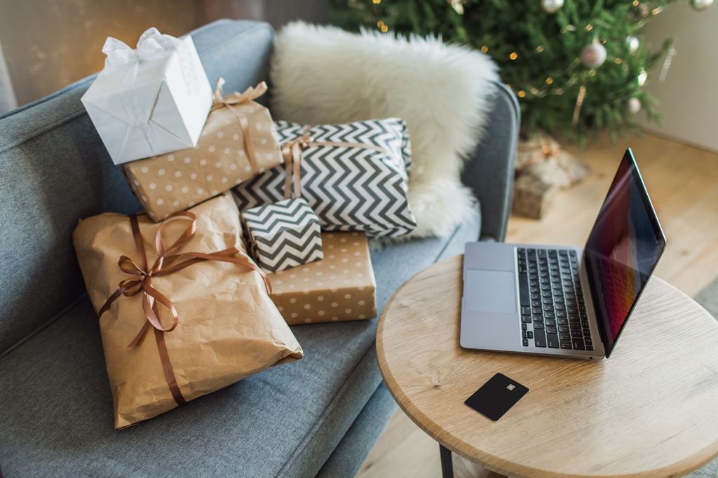 Ordering gifts online, paying by credit card. Concept online shopping, buying Christmas and New Year's presents