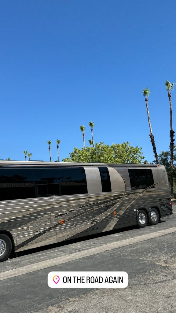Posted by Kourtney Kardashian, a large tour bus sits in a parking lot with palm trees behind 