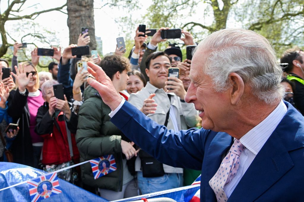 King Charles waving at crowds ahead of the coronation
