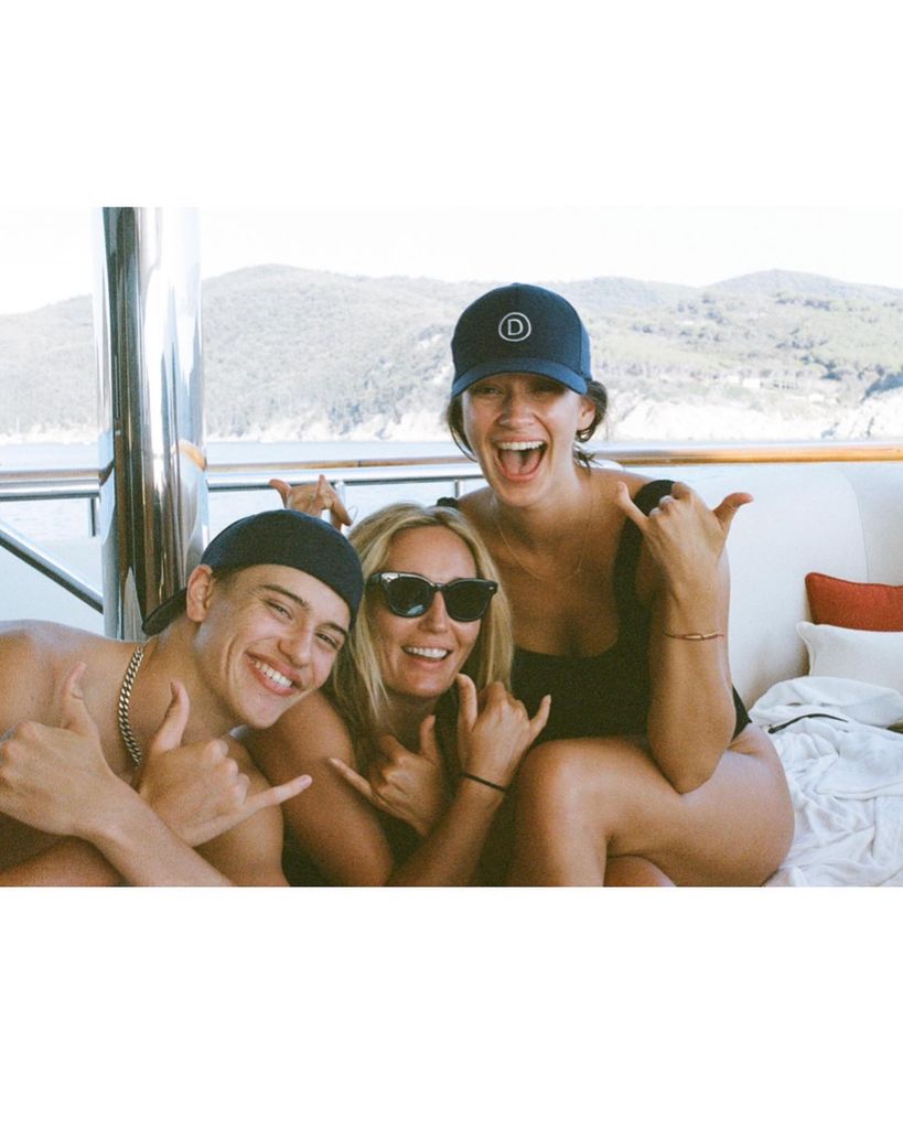 Three people on a boat in the sun 