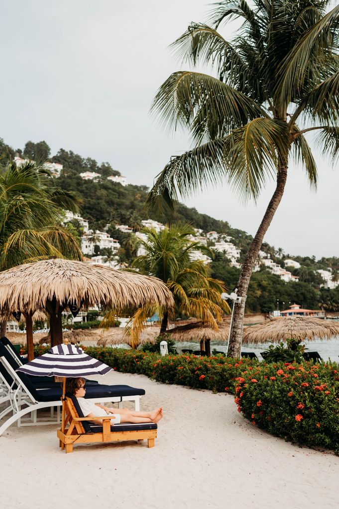 The resort is tucked away on a lush hillside along the cobalt Caribbean Sea