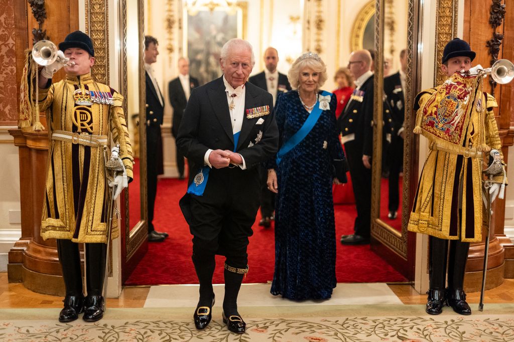 Britain's King Charles III and Britain's Queen Camilla arrive to meet with guests during a reception for members of the Diplomatic Corps at Buckingham Palace