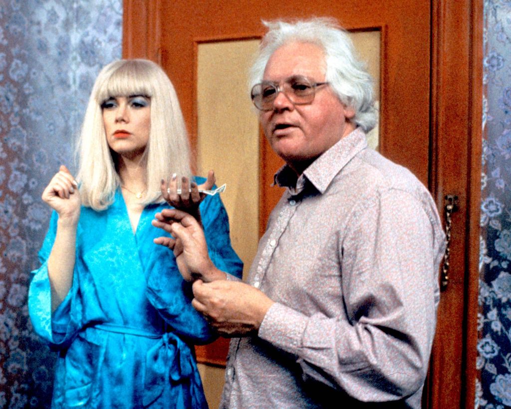 Kathleen Turner, US actress, wearing a blue silk dressing gown, and Ken Russell 