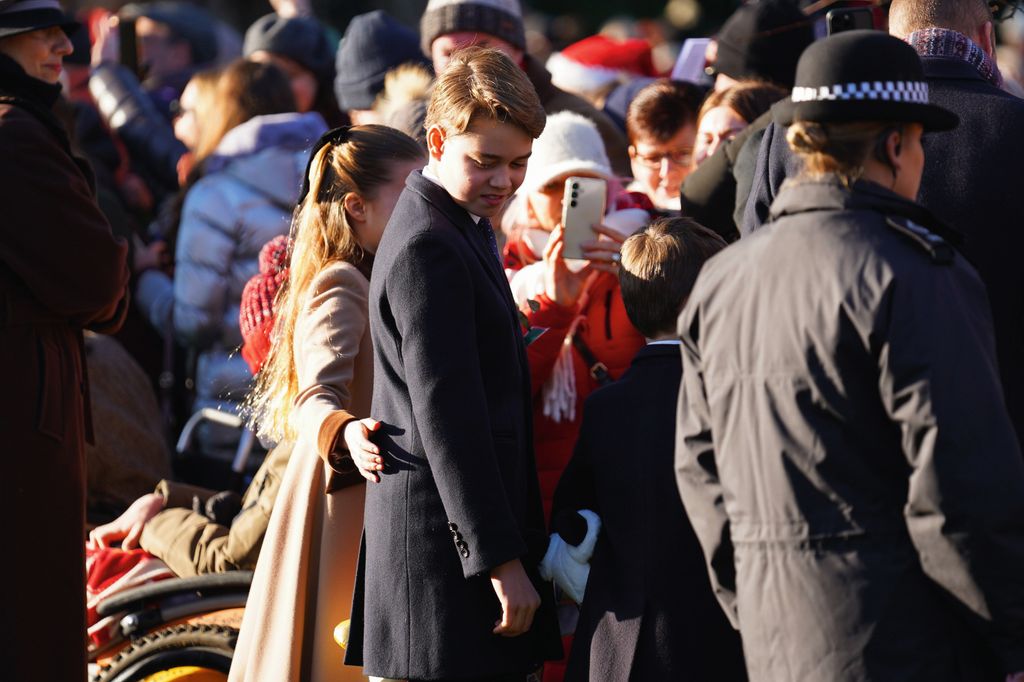 Princess Charlotte places a hand on Prince George's back on Christmas Day
