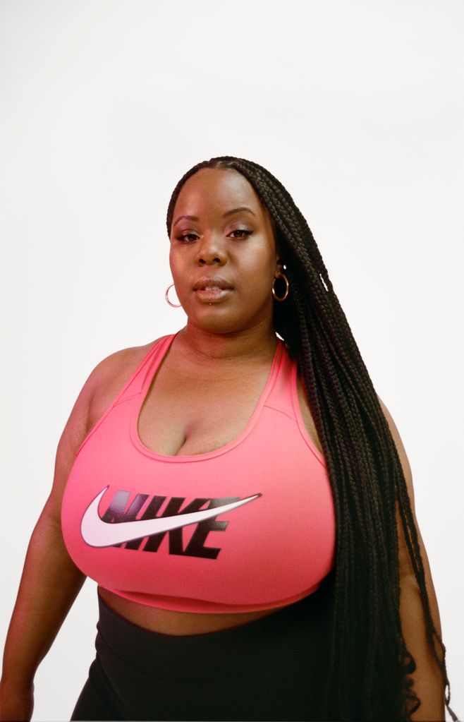 Black woman in a pink Nike top