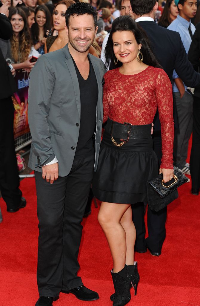 Darren Bennett in a suit and Lilia Kopylova in a red lace dress