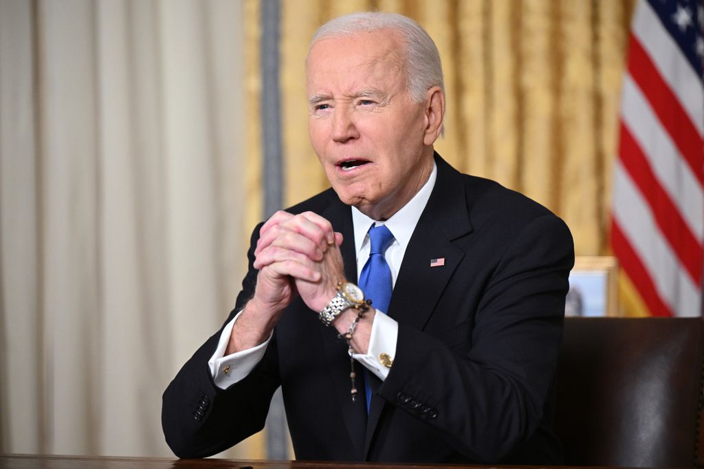 US President Joe Biden clasps his hands as he delivers his farewell address to the nation from the Oval Office of the White House on January 15, 2025 