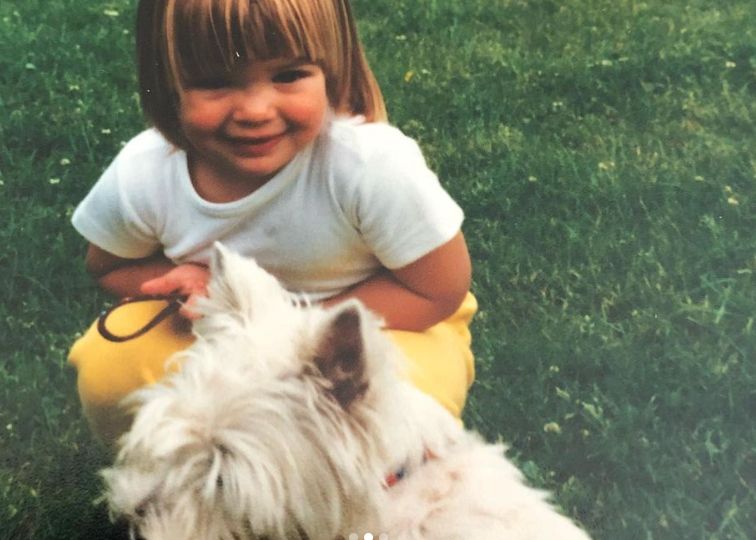 A young Gemma Atkinson in field with Westie dog