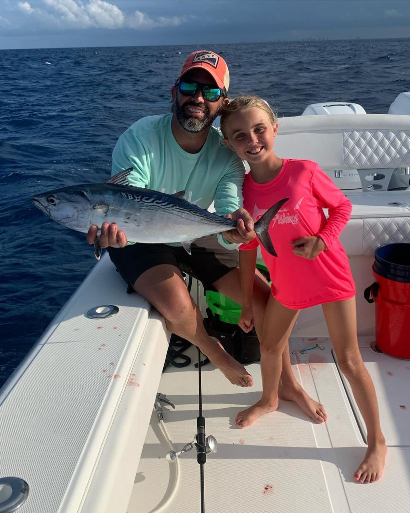 photo of donald trump jr and daugther chloe holding a fish