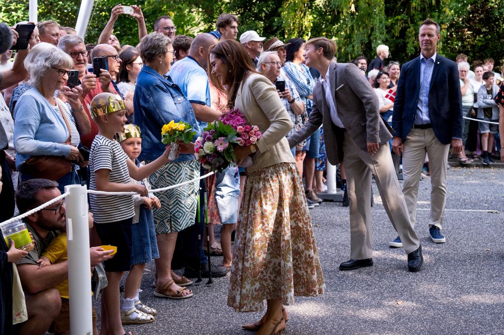 Queen Mary (L) and Prince Vincent (C) of Denmark are greeted by people as they arrive in Graasten, Denmar