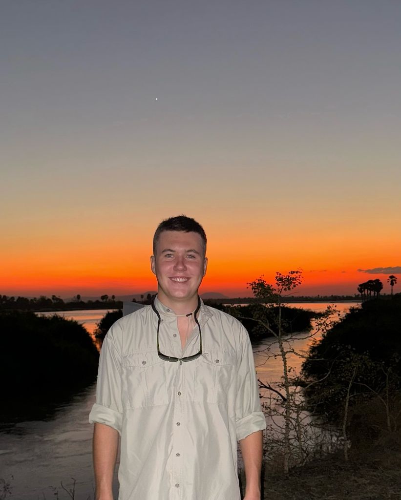 Crown Prince Christian standing in front of a sunset in East Africa