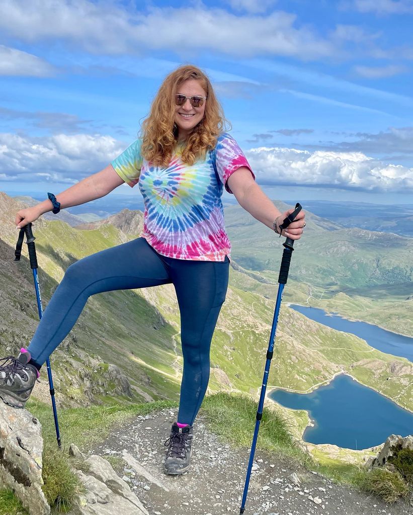 irita marriott in tye dye top hiking up mountain