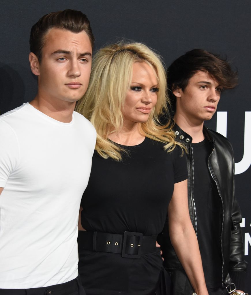 Brandon Thomas standing with Pamela Anderson and Dylan Jagger