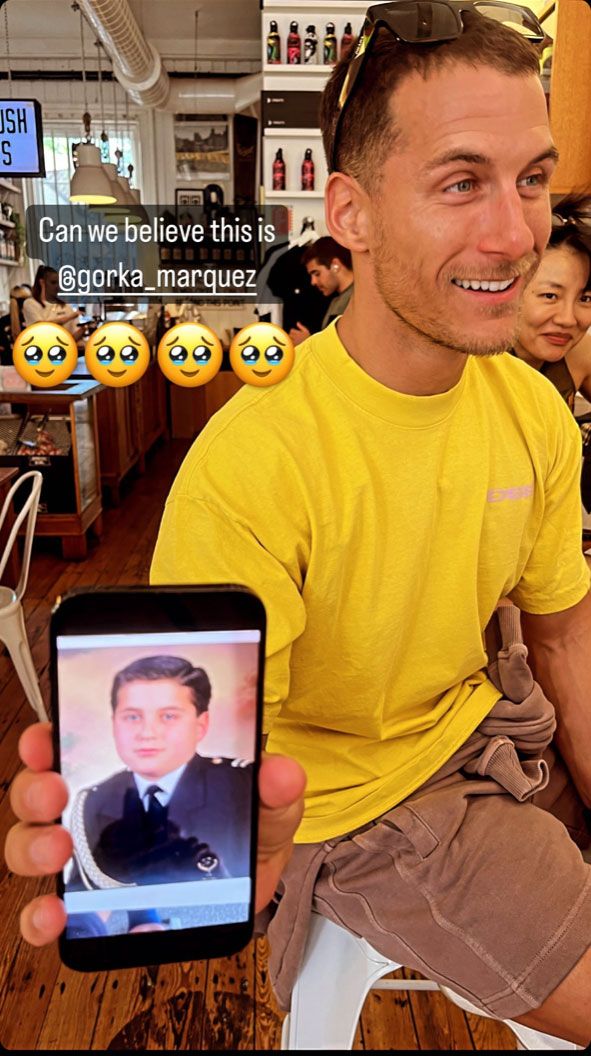 Gorka Marquez smiling as he shows off his First Holy Communion picture on his phone