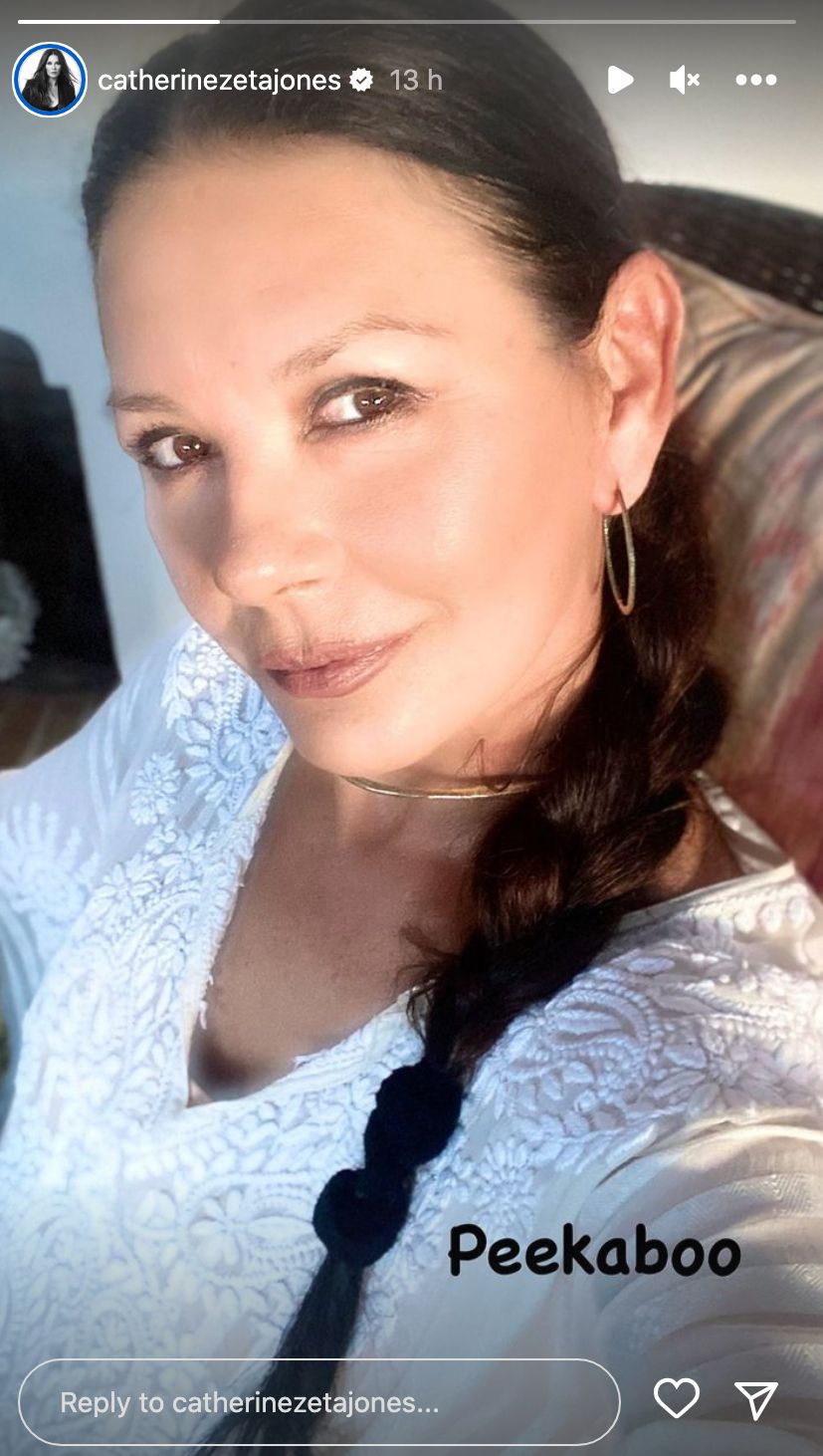 Catherine Zeta-Jones selfie, she's wearing a white beach dress