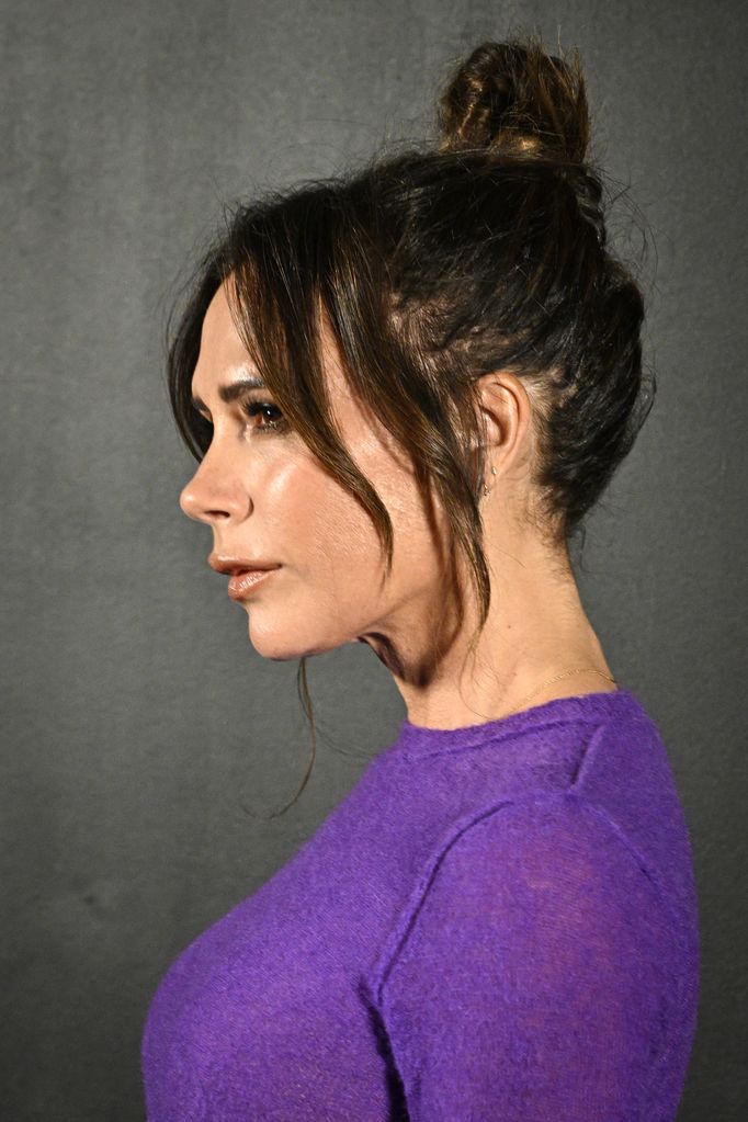 Victoria Beckham side profile photo with her hair tied up