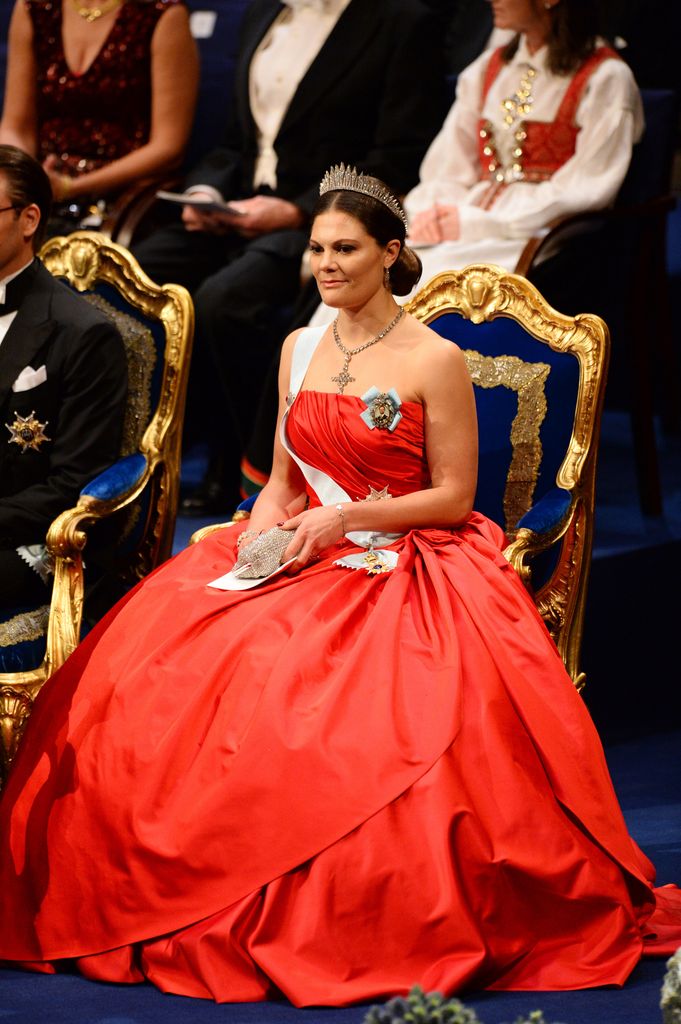 Crown Princess Victoria sat on throne in red strapless gown
