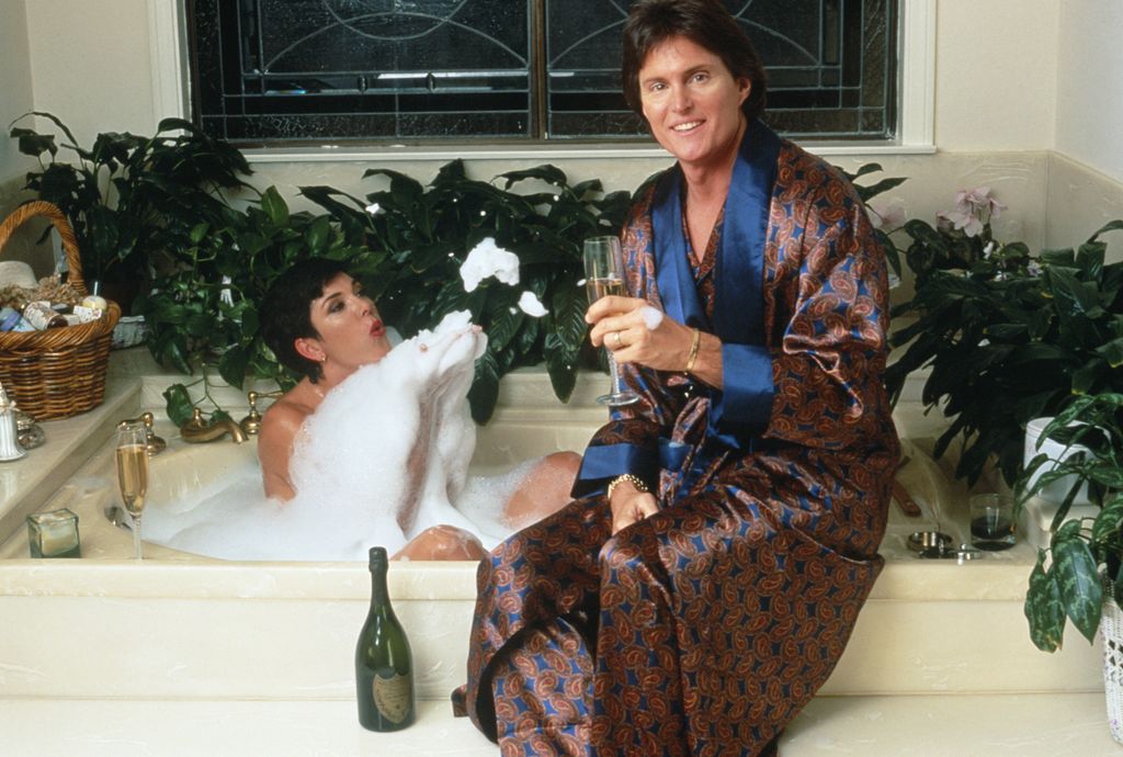 Former US athlete Cailtyn Jenner and his partner Kris Jenner, formerly Kris Kardashian, share a bottle of Dom Perignon over a bubble bath, circa 1991