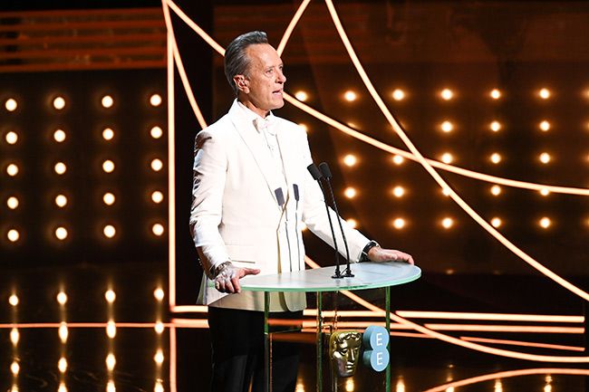 richard e grant on stage at baftas