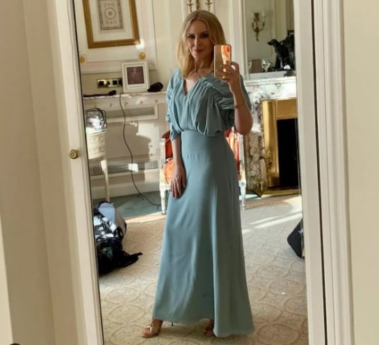 Kylie taking selfie in blue dress in bedroom