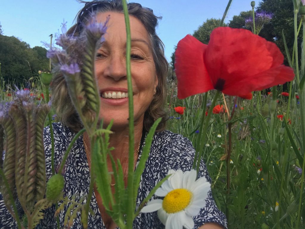 Rebecca Pow MP posing in a field of flowers
