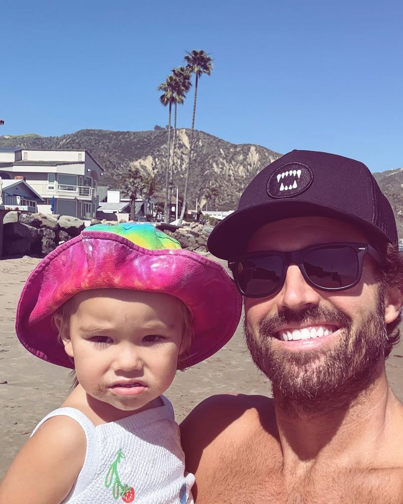 Brody Jenner and his daughter posing at the beach