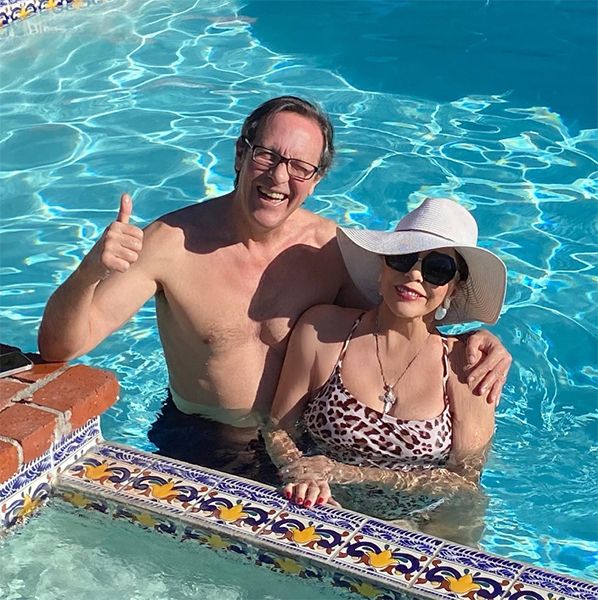 Percy Gibson and Joan Collins in a swimming pool