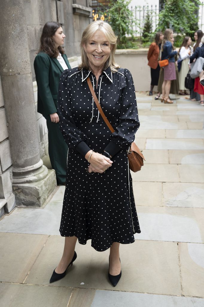 Fern Britton posed on street in black and white polka dot dress