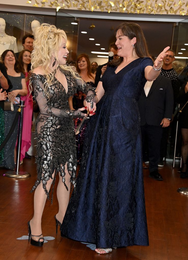 Dolly Parton looking jubilant in a snake print dress
