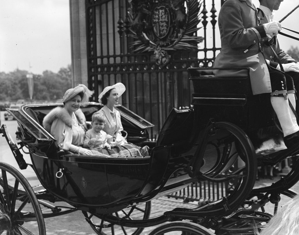 Queen Elizabeth, Queen Consort to King George VI with Princess Margaret Rose (1930 - 2002) and Prince Charles returning to Buckingham Palace after the Trooping The Colour ceremony, at Horse Guards' Parade, London