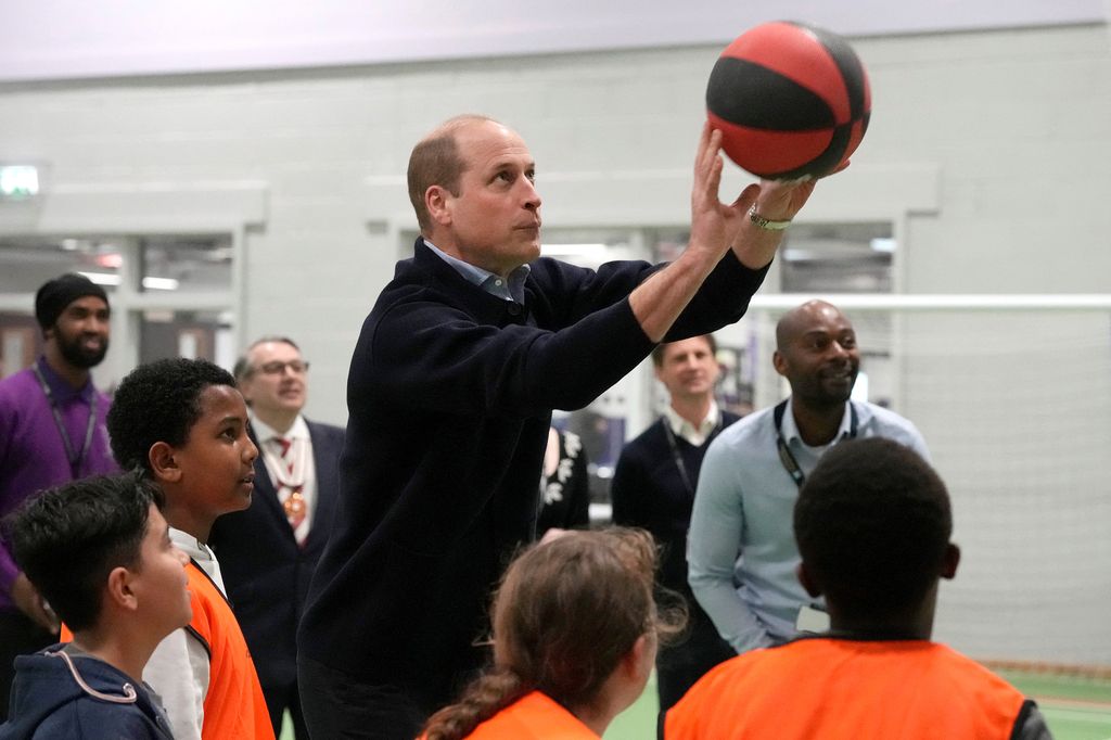 Prince William throws a basketball