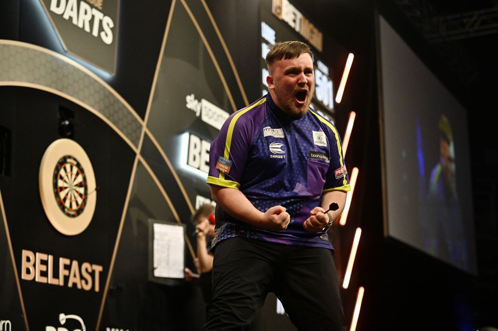 Luke Littler celebrates after defeating Luke Humphries in the opening quarterfinals match at The SSE Arena Belfast on March 28, 2024 in Belfast, Northern Ireland